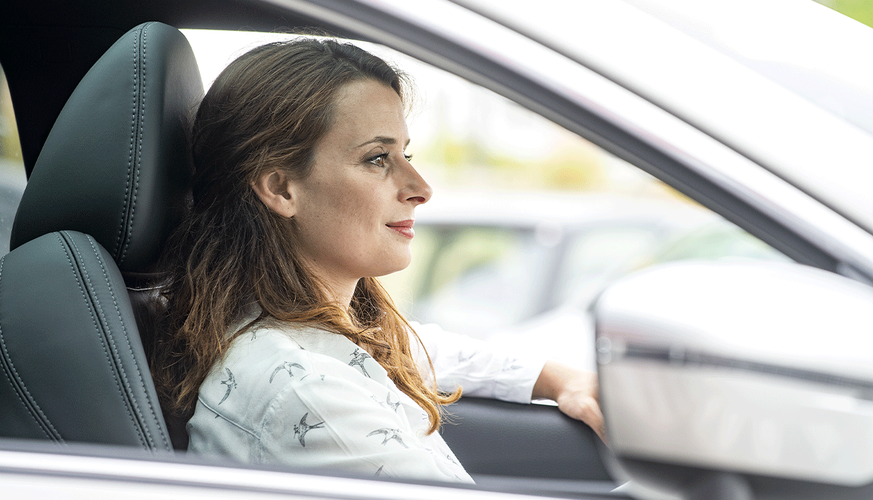 Femme de profil au volant d'une Nissan